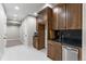 Basement kitchenette with modern cabinetry, sleek countertops, and stainless steel dishwasher at 741 Green Mountain Dr, Erie, CO 80516