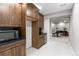 Features kitchenette with sleek black countertops and wood cabinetry, adjacent to a room with piano at 741 Green Mountain Dr, Erie, CO 80516