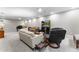 Spacious living room with plush sofas, piano, and a large television for entertaining at 741 Green Mountain Dr, Erie, CO 80516