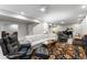 Open living room showcasing neutral furniture, a grand piano, and statement rug at 741 Green Mountain Dr, Erie, CO 80516