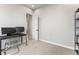 Office space with sleek black desk, shelving, and a view from the bright window at 741 Green Mountain Dr, Erie, CO 80516