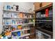 Walk-in pantry with ample shelving and convenient storage next to the beverage refrigerator at 741 Green Mountain Dr, Erie, CO 80516