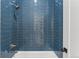 Modern shower with custom blue tile design at 741 Green Mountain Dr, Erie, CO 80516