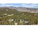 Panoramic aerial view of a forest landscape with multiple homes nestled among trees at 513 Mt Blue Sky Rd, Golden, CO 80401