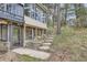 A view of the walkout basement with a glass door, sidelights and a concrete patio with stone steps to the upper level at 513 Mt Blue Sky Rd, Golden, CO 80401