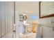Charming bathroom features a pedestal sink, tiled floors, and a decorative mirror at 513 Mt Blue Sky Rd, Golden, CO 80401