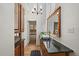 Elegant bathroom with a wood vanity, granite counter, and a view into an adjacent bedroom at 513 Mt Blue Sky Rd, Golden, CO 80401