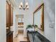 Bathroom featuring a granite countertop, wood-framed mirror, and natural light at 513 Mt Blue Sky Rd, Golden, CO 80401