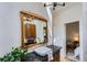 Bathroom featuring a granite countertop, wood-framed mirror, and natural light at 513 Mt Blue Sky Rd, Golden, CO 80401