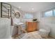 Charming bathroom features a pedestal sink, stone accent wall, and tiled floors at 513 Mt Blue Sky Rd, Golden, CO 80401