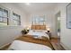 Cozy bedroom with hardwood floors and natural light streaming through the many windows at 513 Mt Blue Sky Rd, Golden, CO 80401