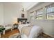 Comfortable bedroom with hardwood floors and natural light streaming through the many windows at 513 Mt Blue Sky Rd, Golden, CO 80401