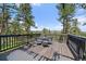 Outdoor deck with table and seating surrounded by pine trees at 513 Mt Blue Sky Rd, Golden, CO 80401