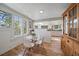 Bright dining area with hardwood floors, white walls, and an abundance of natural light from the many windows at 513 Mt Blue Sky Rd, Golden, CO 80401