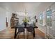 Open dining room with a stone fireplace, skylight, and ample natural light from the many windows at 513 Mt Blue Sky Rd, Golden, CO 80401