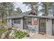 Inviting home exterior with lovely plantings, multiple entry doors, and a cozy seating area at 513 Mt Blue Sky Rd, Golden, CO 80401