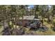 Exterior shot of gray house with sunroom attached in wooded area at 513 Mt Blue Sky Rd, Golden, CO 80401