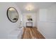 Bright hallway with hardwood floors, fresh paint, and decorative mirror at 513 Mt Blue Sky Rd, Golden, CO 80401