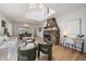 Comfortable living room featuring stone fireplace, hardwood floors, and a skylight at 513 Mt Blue Sky Rd, Golden, CO 80401