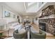 Bright living room featuring hardwood floors and a large stone fireplace at 513 Mt Blue Sky Rd, Golden, CO 80401