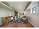 Basement living room with desk, stone floors, and walk out to bedroom at 513 Mt Blue Sky Rd, Golden, CO 80401