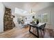 Spacious living room with hardwood floors, stone fireplace, and a skylight at 513 Mt Blue Sky Rd, Golden, CO 80401