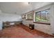 Cozy sunroom with rustic stone wall and tile floor, ideal for a relaxing retreat at 513 Mt Blue Sky Rd, Golden, CO 80401