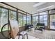 This sunroom features tile flooring, large windows, seating, and a view of the mountains at 513 Mt Blue Sky Rd, Golden, CO 80401