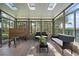 Relaxing sunroom with wall-to-wall windows providing scenic views of the outdoors at 513 Mt Blue Sky Rd, Golden, CO 80401