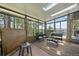 Bright sunroom with many windows and views of the surrounding landscape at 513 Mt Blue Sky Rd, Golden, CO 80401
