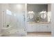 Modern bathroom with a glass-enclosed shower, double vanity, and stylish gray and white finishes at 8505 S Tibet Ct, Aurora, CO 80016