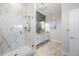Elegant bathroom featuring a walk-in shower with marble tiling, modern vanity, and stylish lighting at 8505 S Tibet Ct, Aurora, CO 80016