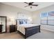 Comfortable bedroom featuring a dark wood bed frame, soft carpet, and large window for natural light at 8505 S Tibet Ct, Aurora, CO 80016
