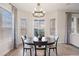 Bright dining area featuring a modern chandelier and sunset mountain views at 8505 S Tibet Ct, Aurora, CO 80016