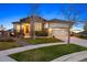 Beautiful home with stone accents, a two-car garage, and a cozy porch under a clear blue sky at 8505 S Tibet Ct, Aurora, CO 80016