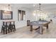 Spacious game room with pool table, bar seating, and comfortable seating at 8505 S Tibet Ct, Aurora, CO 80016
