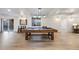 Spacious game room with pool table, bar seating, and sliding door at 8505 S Tibet Ct, Aurora, CO 80016