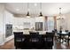 Modern kitchen with white cabinets, granite countertops, stainless steel appliances, and a spacious center island at 8505 S Tibet Ct, Aurora, CO 80016
