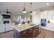 Kitchen island featuring pendant lighting, granite countertops, stainless steel appliances and open floor plan at 8505 S Tibet Ct, Aurora, CO 80016