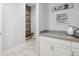 Functional laundry area with a bench, hooks, countertop, and storage cabinets, offering convenience at 8505 S Tibet Ct, Aurora, CO 80016
