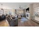 Bright living room with hardwood floors, modern fireplace, comfortable seating, and large windows for natural light at 8505 S Tibet Ct, Aurora, CO 80016