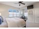 Serene main bedroom with large windows, a ceiling fan, and neutral tones for a relaxing atmosphere at 8505 S Tibet Ct, Aurora, CO 80016