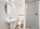 Bright bathroom featuring tile flooring, white walls, single sink, toilet and a shower at 19558 E Purdue Pl, Aurora, CO 80013