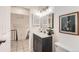 Bathroom featuring a modern vanity, framed art, and view of the hall and stairs at 19558 E Purdue Pl, Aurora, CO 80013
