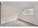 Bedroom featuring neutral gray carpet, white walls, and a single window with blinds at 19558 E Purdue Pl, Aurora, CO 80013