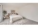 Bedroom featuring a queen bed, soft carpet, and access to sliding glass door to balcony at 19558 E Purdue Pl, Aurora, CO 80013