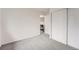 Bedroom featuring plush carpet, closet with sliding doors, and entry to hallway at 19558 E Purdue Pl, Aurora, CO 80013