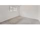 Bright bedroom featuring neutral gray carpet, white walls, and a single window at 19558 E Purdue Pl, Aurora, CO 80013
