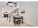 Cozy dining area features a modern chandelier, black table set, and staircase access at 19558 E Purdue Pl, Aurora, CO 80013