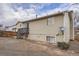 Exterior view of home featuring light siding, deck, patio, stairs, and fenced backyard at 19558 E Purdue Pl, Aurora, CO 80013